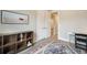 Bedroom with a decorative rug, a bookshelf, and a doorway to the hallway and bathroom at 2144 Coyote Mint Dr, Monument, CO 80132
