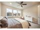 Bright bedroom with three windows offering neighborhood views and white dresser at 2144 Coyote Mint Dr, Monument, CO 80132