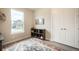 Bedroom with decorative patterned rug, natural light, a cabinet, and double door closet at 2144 Coyote Mint Dr, Monument, CO 80132