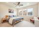 Comfortable bedroom with ample natural light, ceiling fan, and a cozy chair at 2144 Coyote Mint Dr, Monument, CO 80132