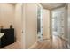 Hallway with bathroom and doorway looking into another room, next to a storage cabinet at 2144 Coyote Mint Dr, Monument, CO 80132