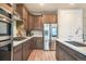 Well-equipped kitchen features stainless appliances, including a double-door refrigerator and modern cabinetry at 2144 Coyote Mint Dr, Monument, CO 80132