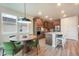 Open concept kitchen with island seating, stainless appliances, and adjacent dining area at 2144 Coyote Mint Dr, Monument, CO 80132