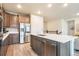 Modern kitchen features stainless steel appliances, a center island, and beautiful hardwood flooring at 2144 Coyote Mint Dr, Monument, CO 80132
