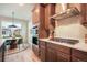 Gourmet kitchen features built-in appliances and a cooktop, with an adjacent dining area at 2144 Coyote Mint Dr, Monument, CO 80132