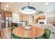 Well-lit kitchen flows into the living area with a fireplace and modern décor at 2144 Coyote Mint Dr, Monument, CO 80132