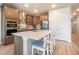 Updated kitchen features stainless appliances, ample counter space, and seating at the island at 2144 Coyote Mint Dr, Monument, CO 80132
