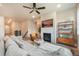 Open-concept layout from living room to kitchen; fireplace and comfortable seating create a cozy and inviting space at 2144 Coyote Mint Dr, Monument, CO 80132