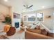 Bright living room featuring a fireplace, comfortable seating, and large windows with neighborhood views at 2144 Coyote Mint Dr, Monument, CO 80132