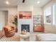 Cozy living room features a tiled fireplace, modern decor, and lots of natural light at 2144 Coyote Mint Dr, Monument, CO 80132