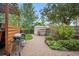 Charming backyard featuring a brick patio, grill, and lush greenery, ideal for outdoor gatherings and relaxation at 4982 S Danube St, Aurora, CO 80015