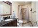 Bathroom with vanity, shower, updated fixtures, and wood-look flooring at 4982 S Danube St, Aurora, CO 80015