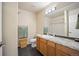 Bright bathroom with granite counters, wooden cabinets, and tile floors at 4982 S Danube St, Aurora, CO 80015