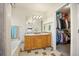 Bright bathroom with a double vanity sink, closet, bathtub, and mirrors at 4982 S Danube St, Aurora, CO 80015