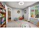 Bright bedroom with neutral walls, carpet, window, view of outside, and decor for children to enjoy at 4982 S Danube St, Aurora, CO 80015