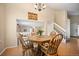 Dining area features an octagonal table and views of the staircase and living room at 4982 S Danube St, Aurora, CO 80015