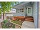 Inviting front porch with decorative railing and landscaped garden at 4982 S Danube St, Aurora, CO 80015