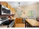 Well-lit kitchen features stainless steel appliances, wood cabinets, and an island at 4982 S Danube St, Aurora, CO 80015