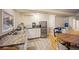 Basement kitchenette with white cabinets and stainless steel appliances at 4982 S Danube St, Aurora, CO 80015