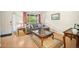 Cozy living room with light hardwood floors and a large window at 4982 S Danube St, Aurora, CO 80015