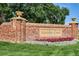 Elegant brick community entrance sign for Murphy Creek, adorned with colorful flowers and manicured landscaping at 2145 S Ider Way, Aurora, CO 80018