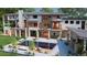 An outdoor living space featuring a gorgeous pool, patio, lush greenery, and a multi-level home with stone accents at 1757 Whistlepig Ln, Broomfield, CO 80020