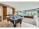 Finished basement with air hockey table, seating area, fireplace, and wine storage at 1757 Whistlepig Ln, Broomfield, CO 80020