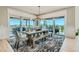 Elegant dining room with a rustic table, bench seating, stylish chandelier, and access to an outdoor area at 1757 Whistlepig Ln, Broomfield, CO 80020
