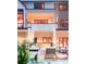 View of home's rear elevation featuring a covered patio with pool-side lounge furniture at 1757 Whistlepig Ln, Broomfield, CO 80020