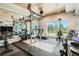 Home gym with mirrored walls, weight lifting equipment, and access to the outdoor patio at 1757 Whistlepig Ln, Broomfield, CO 80020