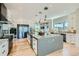Spacious kitchen with a large island, wine fridge, pendant lights, and ample counter space for cooking at 1757 Whistlepig Ln, Broomfield, CO 80020