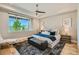 Bright main bedroom suite featuring a large window, hardwood floors, tray ceiling, and modern decor at 1757 Whistlepig Ln, Broomfield, CO 80020