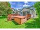 Inviting backyard featuring a wooden deck with a hot tub and a well-maintained lawn at 379 Lincoln Ct, Louisville, CO 80027