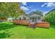 Landscaped backyard with wooden deck, hot tub, and ample grass at 379 Lincoln Ct, Louisville, CO 80027