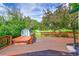 Relaxing backyard deck with a hot tub overlooking the lush, green landscape at 379 Lincoln Ct, Louisville, CO 80027