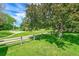 Beautiful backyard with a well-manicured lawn, mature trees, and a charming wooden fence at 379 Lincoln Ct, Louisville, CO 80027