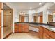 Bathroom featuring wooden cabinetry, granite countertop, tiled floors, walk-in shower and a large mirror at 379 Lincoln Ct, Louisville, CO 80027