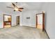 Bright bedroom featuring carpet flooring, ceiling fan, three entryways and wall-mounted television bracket at 379 Lincoln Ct, Louisville, CO 80027