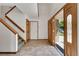 Bright foyer with tile flooring, an open staircase, and a decorative wood door at 379 Lincoln Ct, Louisville, CO 80027