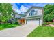 Well-maintained two-story home with a spacious driveway and a green, landscaped lawn at 379 Lincoln Ct, Louisville, CO 80027