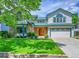 Charming two-story home featuring stone accents, well-manicured lawn and lush landscaping at 379 Lincoln Ct, Louisville, CO 80027