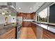 Well-lit kitchen featuring stainless steel appliances, wooden cabinets, granite countertops and hardwood floors at 379 Lincoln Ct, Louisville, CO 80027