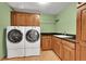 Laundry room featuring modern washer and dryer, wood cabinets, sink, granite countertops and hardwood floor at 379 Lincoln Ct, Louisville, CO 80027