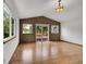 Well-lit living room featuring hardwood floors, textured accent wall, and sliding glass door leading to outdoor deck at 379 Lincoln Ct, Louisville, CO 80027