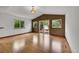 Living room featuring hardwood floors, accent wall, three windows and a glass door leading to outdoor deck at 379 Lincoln Ct, Louisville, CO 80027