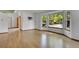 Bright living room with hardwood floors and large windows overlooking a tree-lined street at 379 Lincoln Ct, Louisville, CO 80027