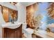 This powder room has a tropical mural and a pedestal sink with bronze fixtures at 379 Lincoln Ct, Louisville, CO 80027