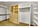 Spacious walk-in closet with custom built-in shelving, drawers, full length mirror, and hanging rods at 379 Lincoln Ct, Louisville, CO 80027