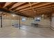 Unfinished basement with exposed ceiling beams and concrete floor, offering potential for customization at 2090 S Gray Dr, Lakewood, CO 80227