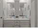 Bright bathroom features a double vanity with white cabinets and large mirrors at 2090 S Gray Dr, Lakewood, CO 80227